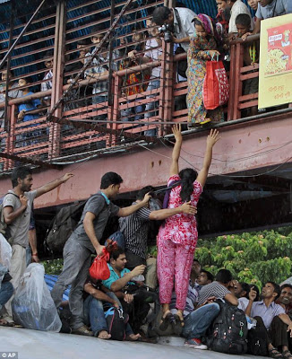 There's actually a train under there... Mass of people try to get on board as millions celebrate the end of Ramadan  Article-2386458-1B30574D000005DC-832_634x779