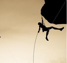 هـــــل ستقطــــــع الحبـــــــل Stock-photo-team-of-rock-climbers-silhouetted-on-the-summit-dangle-in-midair-rappelling-from-a-rock-spire-in-26065156