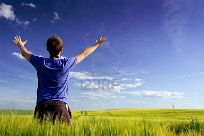 الحرية الحقيقية 7627054-man-standing-on-the-green-field-at-summer-and-feel-the-freedom