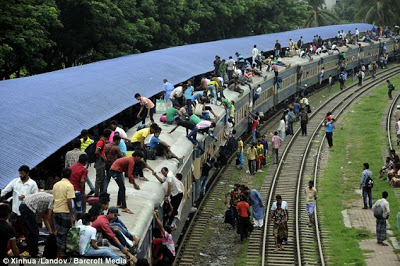 There's actually a train under there... Mass of people try to get on board as millions celebrate the end of Ramadan  Article-2386458-1B303128000005DC-229_634x421