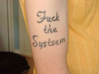 Jesse McDonell / I.A. Fuck-the-systsem-misspelled-tattoo