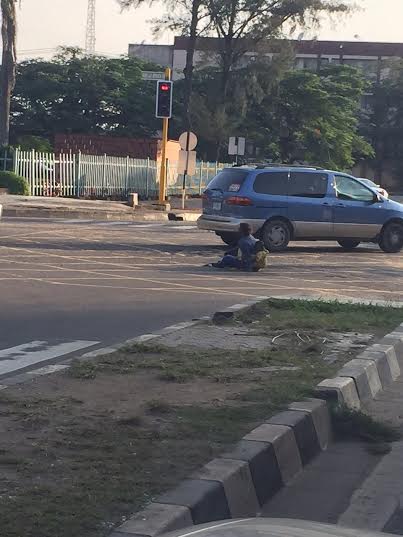 Woman With Baby Sits In The Middle Of Road Around Lagos Government House 1