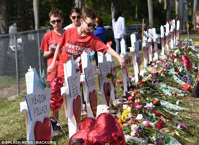 The Serious Side - part 4 - Page 14 4963771200000578-5410419-Children_lay_flowers_at_the_crosses_for_the_17_victims_for_the_V-a-8_1519080132911