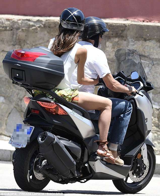 George and Amal cruising Sardinia on a motorbike 4CE8D72D00000578-0-Just_the_two_of_us_The_couple_appear_to_have_left_their_twins_Al-m-114_1528141638330