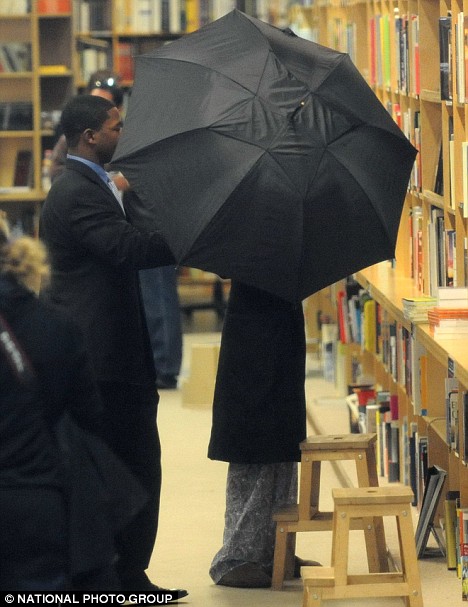 Gimme shelter: Michael Jackson goes shopping in his pyjamas and surgical mask... hiding under an umbrella INSIDE Article-0-02EDAE7A000005DC-126_468x607