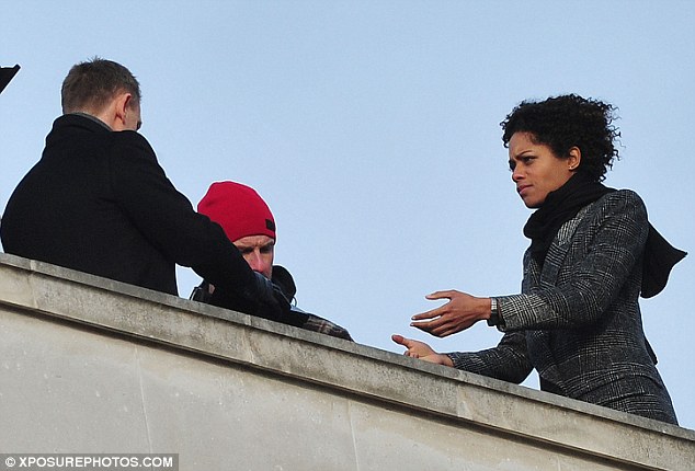 Bond is back: Daniel Craig is spotted filming scenes for upcoming film Skyfall on a London rooftop alongside Naomie Harris Article-0-0F10103D00000578-833_634x430