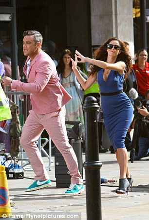 Robbie Williams' body double takes the hit as cars smash into him for the singer's new hard-hitting music video  Article-2189253-1491EBD9000005DC-199_306x452