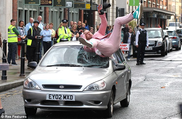 Robbie Williams' body double takes the hit as cars smash into him for the singer's new hard-hitting music video  Article-2189253-14925579000005DC-716_634x416