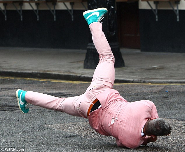 Robbie Williams' body double takes the hit as cars smash into him for the singer's new hard-hitting music video  Article-2189253-14927688000005DC-62_634x524