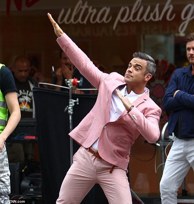 Robbie Williams' body double takes the hit as cars smash into him for the singer's new hard-hitting music video  Article-2189253-1492D686000005DC-274_634x667