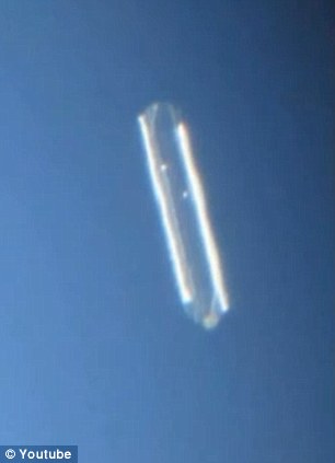 Man photographs hovering cigar-shaped UFO for over two hours as it is witnessed by  Article-2223645-15B33E3B000005DC-459_306x423