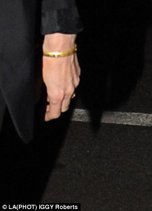 Angelina Jolie removes her extravagant engagement bling  Article-2299044-18E9A39E000005DC-217_306x423