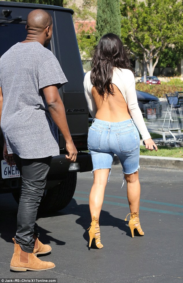 Kim Kardashian dons bizarre ensemble of denim Bermuda shorts, open-back top 1413760885242_wps_58_Junk_food_alert_Kim_Karda