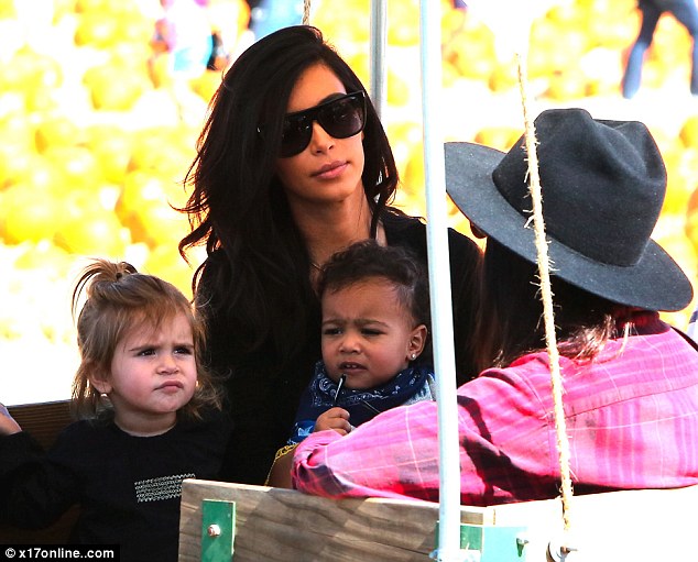 Are Kim and Kanye turning North into the world's youngest fashion victim 1413816892279_wps_4_Kim_Kourtney_Kanye_sad_Kr