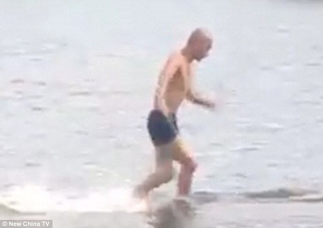 Chinese Shaolin monk runs on water for 125 metres… breaking his own record by five metres  2BF69BB100000578-3222244-Running_on_water_Wearing_only_a_pair_of_black_shorts_and_with_hi-m-46_1441364153787