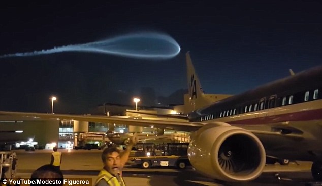 Incoming! Miami Airport workers' disbelief as 'UFO' trailing blue smoke flies over the runway  3686FA9100000578-3704560-image-a-33_1469269215658