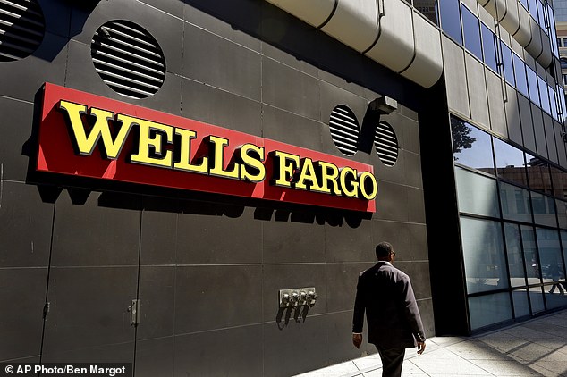 Warren Buffett loses $1.4billion in ONE DAY as Wells Fargo stocks plummet,  4Nb9l7W3r1ba33c6463f775bbc83-3787292-FILE_In_this_July_14_2014_file_photo_a_man_passes_by_a_Wells_Far-a-66_1473825957950