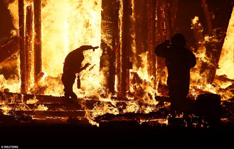 Stunned Burning Man festival-goers watch in horror as man dodges firefighters and rangers to dive into flames of blazing effigy 43DB4D1D00000578-4848026-image-a-25_1504427167733