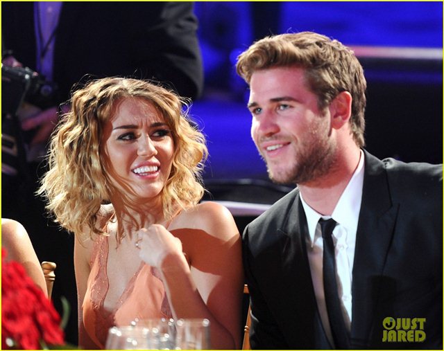 Miley Cyrus and Liam Hemsworth at Celebrity Fight Night >>  9614ca1d6a55f98015d93118a4bcb67e