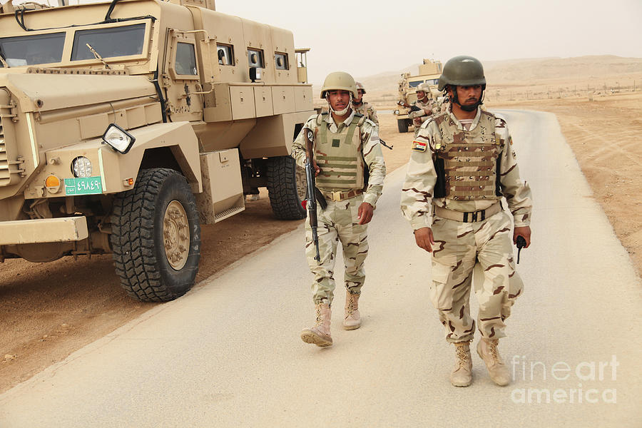 اكبر و اوثق موسوعة للجيش العراقي على الانترنت Iraqi-army-soldiers-walk-beside-an-mrap-stocktrek-images