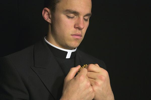 Le coming out du prêtre polonais, un geste très grave et irresponsable Young-priest-praying-with-rosery-gregory-dean