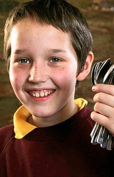 Boy Balancing 16 Spoon On His Face AllisonDM0304_228x355