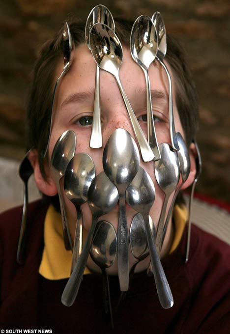 Boy Balancing 16 Spoon On His Face SpoonsSWNS0304_468x680