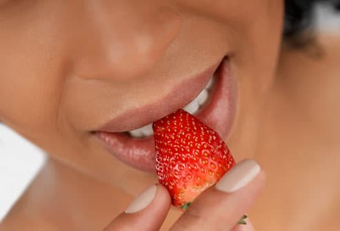 10 Ways to Reduce Stress & Revitalize Your Life Getty_rf_photo_of_woman_eating_strawberry