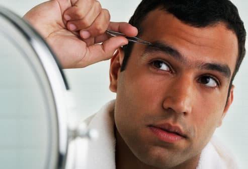 Embarrassing Male Body Problems Getty_rf_photo_of_man_tweezing_eyebrows