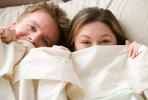 15 Secrets Guys Wish women Knew !!! Getty_rf_photo_of_couple_smiling_under_sheets