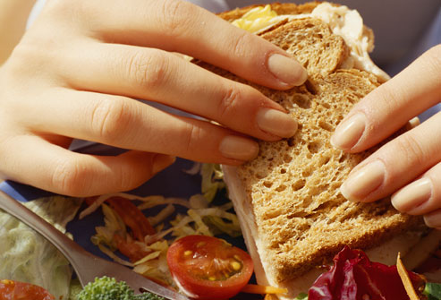 Top 24 Ways to Lose Weight Without Dieting Getty_rf_photo_of_woman_eating_sandwich