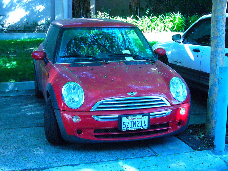 Red Mini Cooper in front of building 475 296968313_mxQWN-L