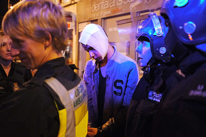 Riots in London and Beyond in pictures An-injured-man-is-led-to--012