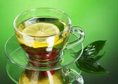 Билколечение 10321052-green-tea-in-transparent-cup-with-lime-and-berry-on-green-background