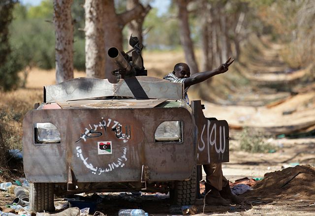 ce que j'ai commis  - Page 2 Libyan_rebel_fighter_in_a_vehicle_rigged_with_armour_plates_13_June_2011_near_Zlitan_001