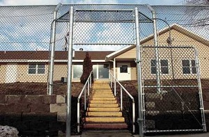 The definitive way to hold back Zombies An-eight-foot-tall-chain-link-fence-featuring-no-climb-mesh-and-an-motion-sensor-alarm-system-surrounds-the-pendleton-house-on-the-campus-of-the-eastern-oregon-training-center-in-pendleton