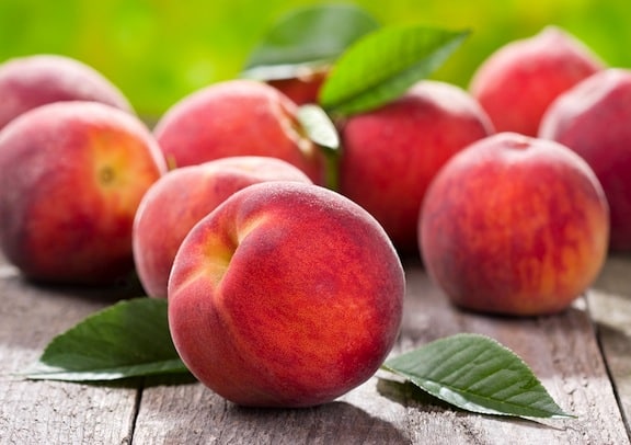 The peach tree is one of the finest fruit trees Peaches-on-table