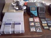 Super Nintendo Entertainment System (SNES)  with controllers and Gameboy (Color, Super) with cases and games.