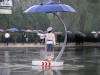 Rain will not prevent the Pyongyang Traffic Women from directing traffic - umbrella and poncho keep them dry.

from hanming_huang flickr page