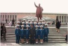 The traffic police pose under the big huge giant bronze statue of Kim Il-Sung, the beloved Great Leader of the DPRK