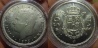 50 Pesetas. Juan Carlos I. Ceca: Madrid. Año: 1979 (19-79 en estrellas). Metal: Cuproníquel (Cobre 750 y Níquel 250 milésimas). Peso: 12,5 gr. Diámetro: 30mm. Canto: Leyenda en relieve 
"UNA**GRANDE**LIBRE**". Defecto de acuñación en anverso delante de la palabra "DE" a la altura de la orla de puntos y el listel. Tirada en calidad normal: 32.700.000. Tirada en Acabado ARM: 300.000. Diseñadores/Grabadores: Anverso/ Manuel Marín. Reverso/ Francisco Martínez Tornero. Orden Ministerial: 3479 19/12/1975. Esta moneda proviene de una cartera del año 1979 de la FNMT. Dicha cartera consta de 4 valores (1, 5, 25 y 50 Pesetas). Las monedas de esta cartera fueron acuñadas en acabado ARM (Acuñación en Relieve Mateado). La tirada de esta cartera fue de 300.000 unidades.