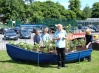 The boat newly painted in school colours is planted  by the pupils